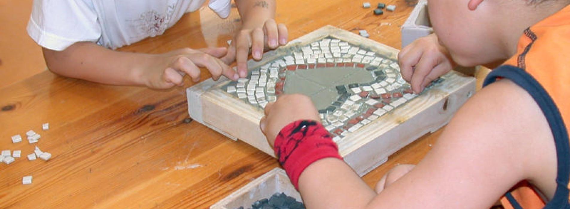 Enfants réalisant un atelier de mosaïque