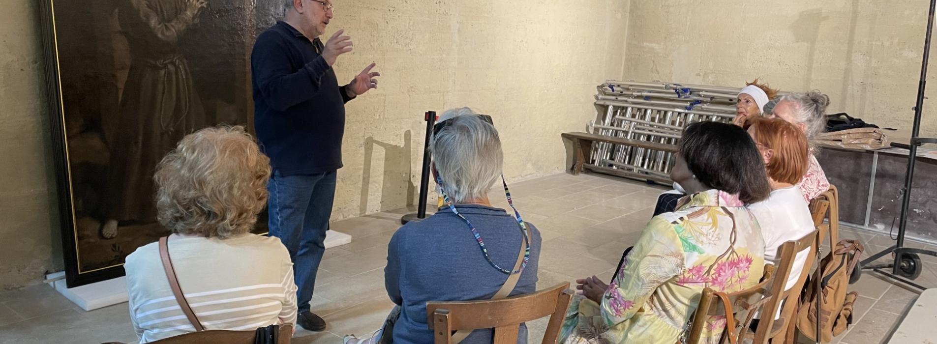 Marc Favreau devant le tableau de St François